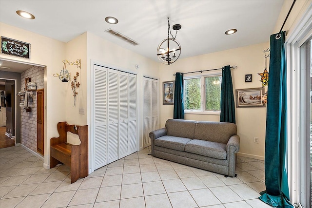 living area featuring light tile patterned flooring and a chandelier