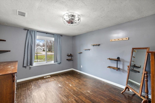 interior space with dark hardwood / wood-style flooring and a textured ceiling