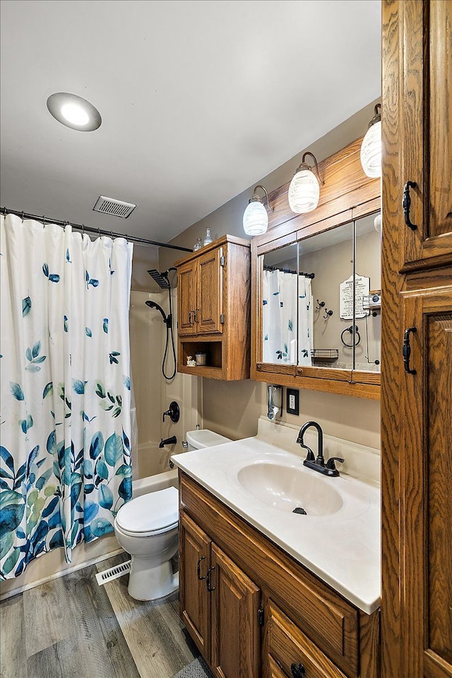 full bathroom featuring shower / bath combo, toilet, wood-type flooring, and vanity