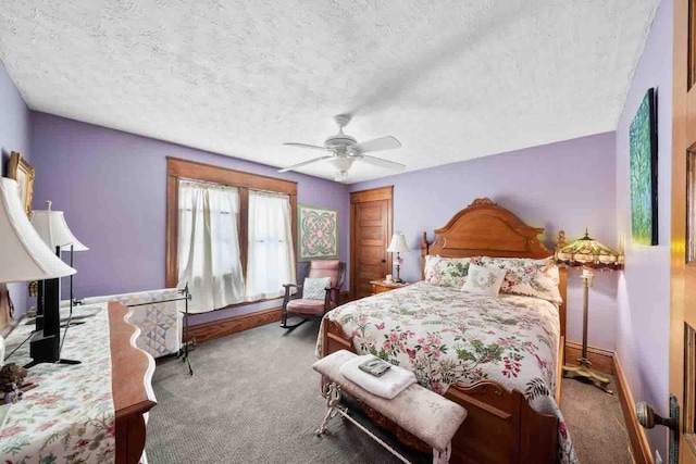 carpeted bedroom with ceiling fan and a textured ceiling