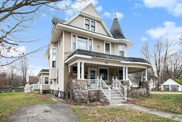 victorian house with covered porch and a front lawn