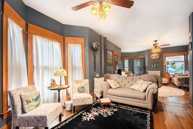 living room featuring wood-type flooring, a wealth of natural light, and ceiling fan