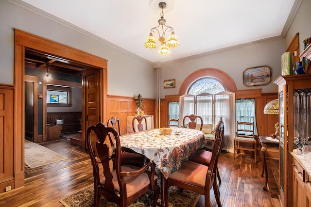 dining room featuring a notable chandelier, dark hardwood / wood-style flooring, and crown molding