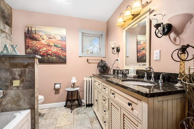 bathroom featuring a tub, radiator, vanity, and toilet