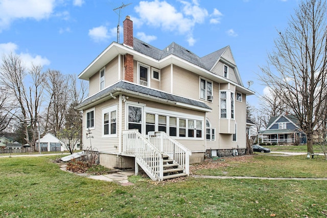 back of property featuring a lawn