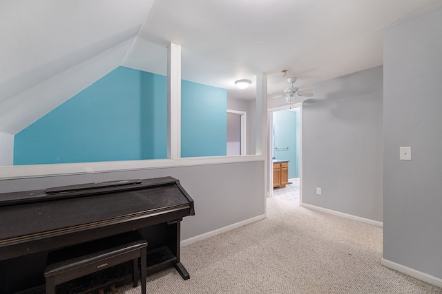 interior space featuring light carpet and vaulted ceiling