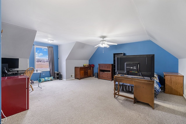 carpeted home office with ceiling fan and vaulted ceiling