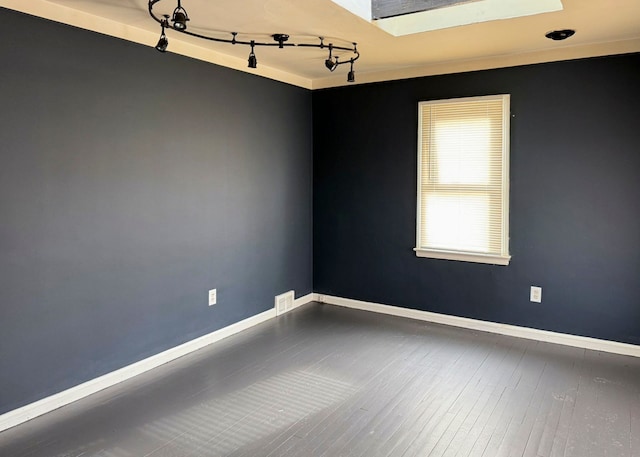 spare room featuring wood-type flooring