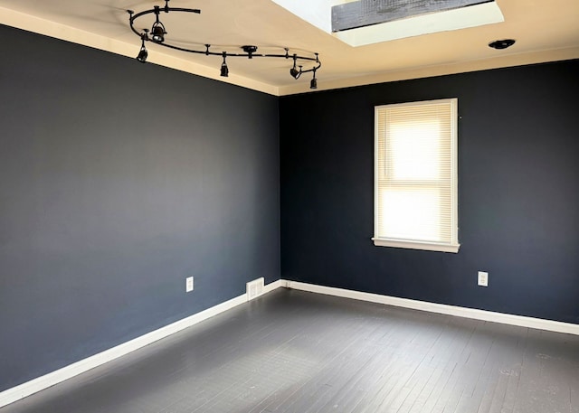 unfurnished room with wood-type flooring and a skylight