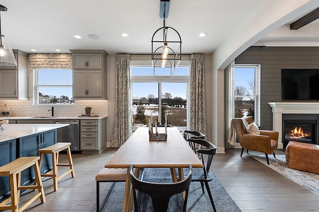 dining area featuring sink, a healthy amount of sunlight, and light wood-type flooring