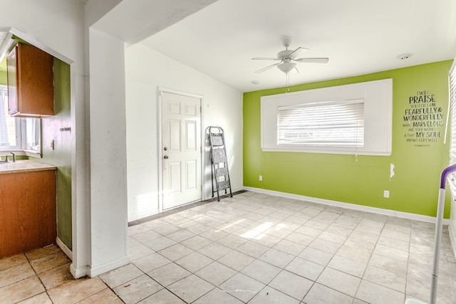 tiled spare room with ceiling fan, lofted ceiling, and a wealth of natural light