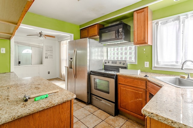 kitchen featuring ceiling fan, a healthy amount of sunlight, sink, and appliances with stainless steel finishes