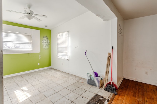 spare room with light hardwood / wood-style floors, plenty of natural light, lofted ceiling, and ceiling fan