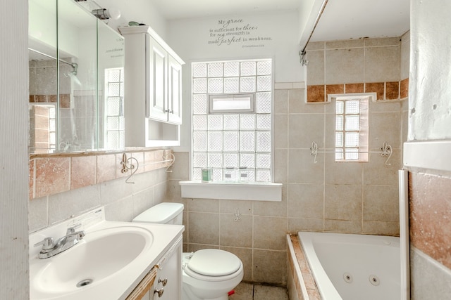 bathroom featuring a tub, vanity, tile walls, and toilet