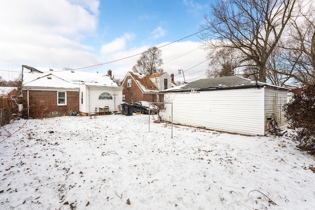 view of snow covered rear of property