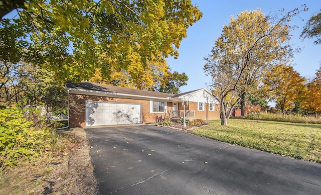 view of front of property featuring a garage and a front lawn