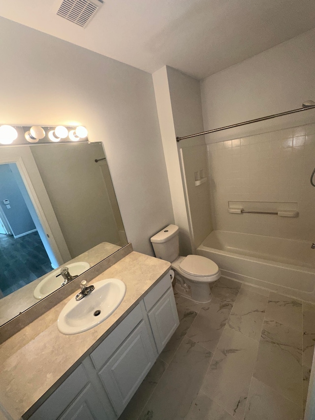 full bathroom with vanity, toilet, and tiled shower / bath