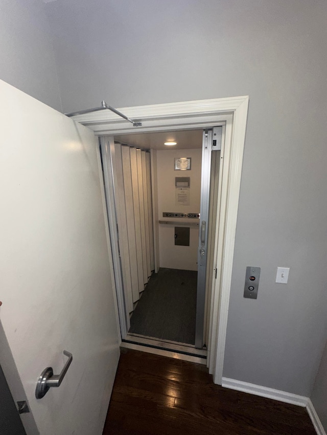 hallway with dark hardwood / wood-style flooring