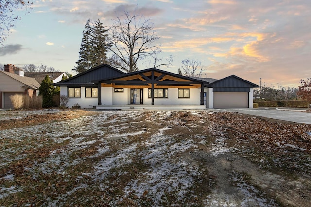 view of front of property featuring a porch and a garage