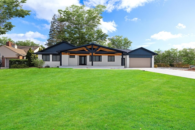 view of front of property featuring a garage and a front lawn