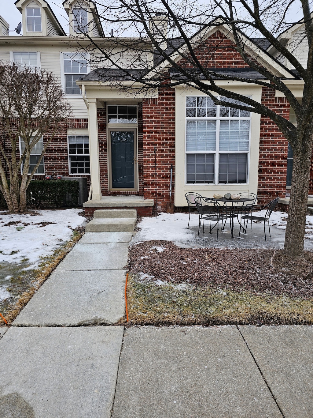 view of snow covered property entrance