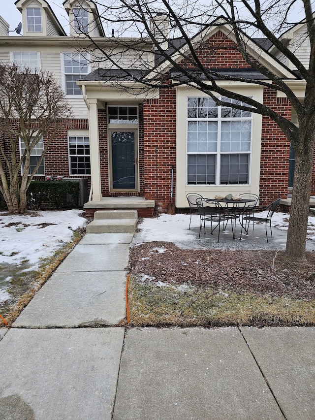 view of snow covered property entrance