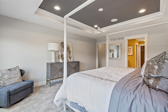 bedroom featuring a raised ceiling and light colored carpet