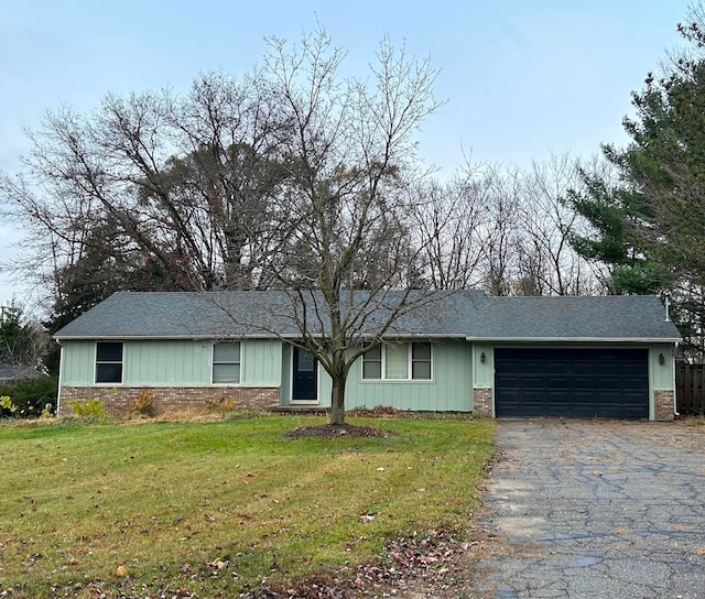 ranch-style house with a front lawn and a garage