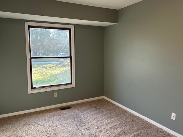 carpeted empty room featuring plenty of natural light