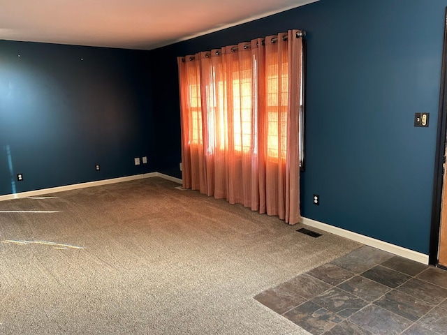 empty room featuring dark carpet