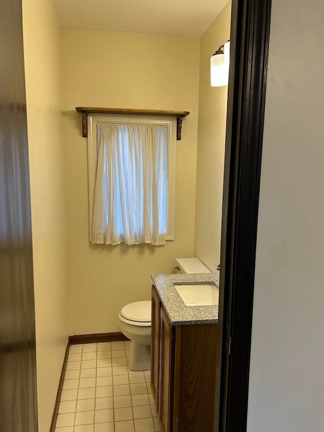 bathroom featuring toilet, vanity, and tile patterned floors