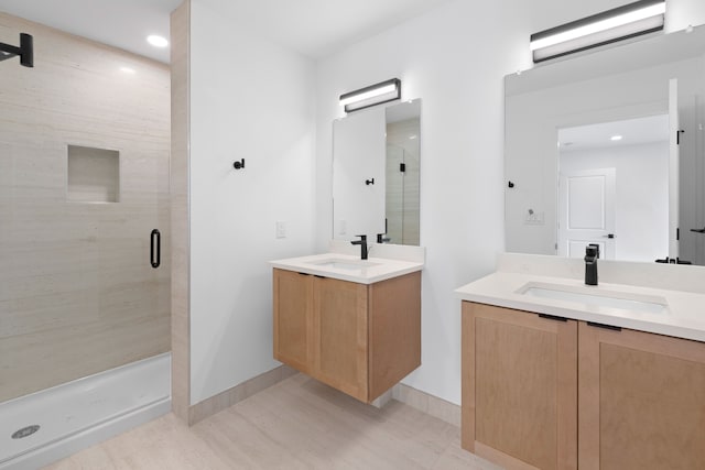 bathroom featuring vanity and a shower with door