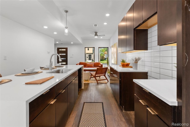 3422 Cochrane St Unit 1, Detroit, MI 48208 - kitchen featuring a sink, light countertops, dark wood-type flooring, recessed lighting, and open floor plan