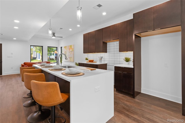 3422 Cochrane St Unit 1, Detroit, MI 48208 - kitchen with a sink, recessed lighting, baseboards, light countertops, and dark wood finished floors