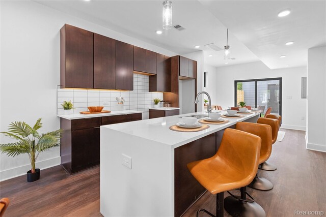 3422 Cochrane St Unit 1, Detroit, MI 48208 - kitchen featuring a sink, baseboards, dark wood finished floors, light countertops, and recessed lighting