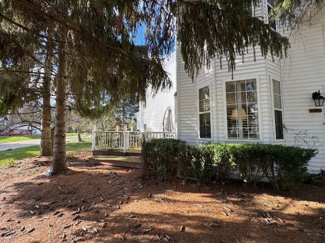 view of home's exterior featuring a wooden deck