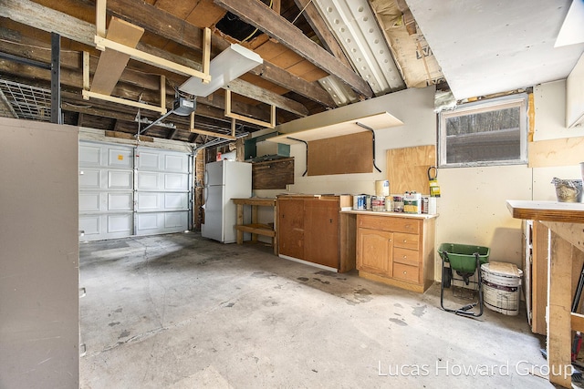 garage with white refrigerator and a garage door opener