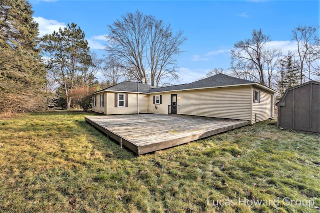 rear view of property with a lawn and a wooden deck