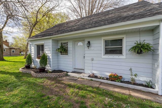 doorway to property with a yard