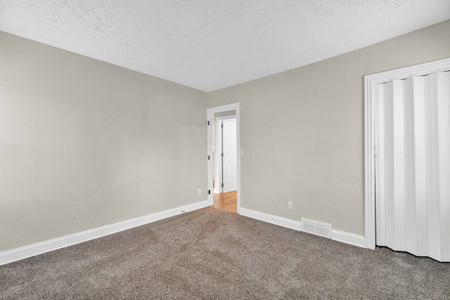 unfurnished bedroom featuring carpet floors and a textured ceiling