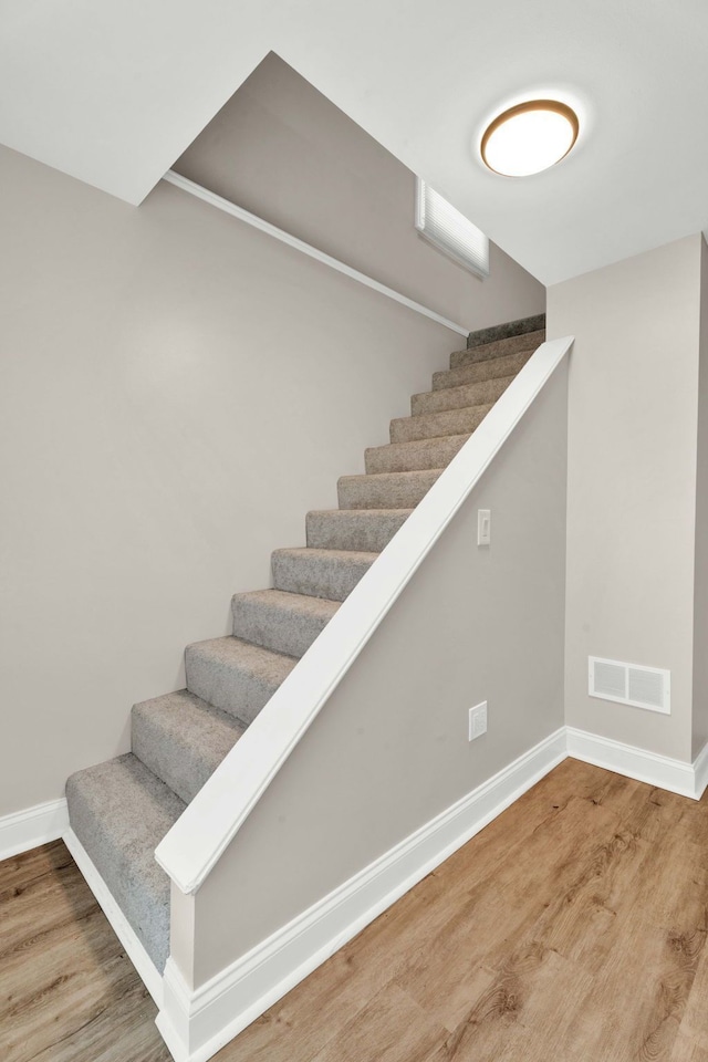 staircase featuring hardwood / wood-style flooring