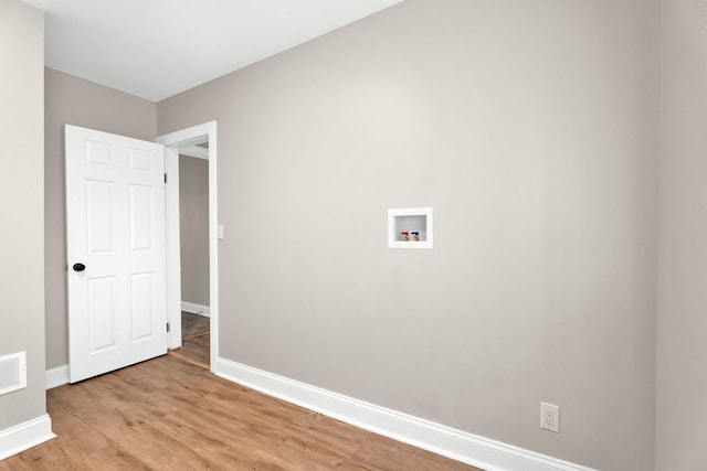 laundry area featuring hookup for a washing machine and light hardwood / wood-style floors