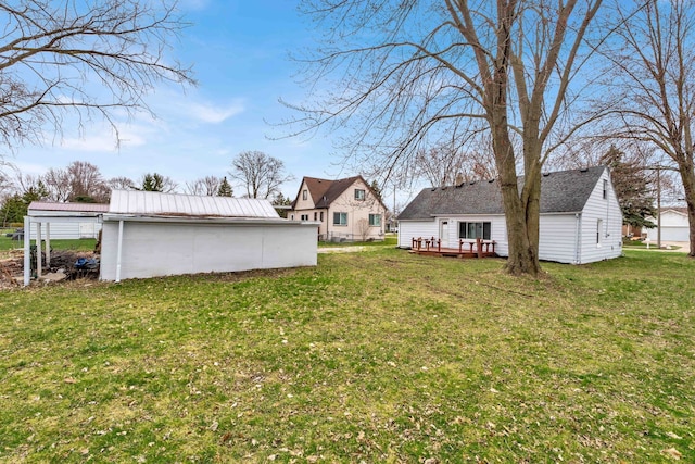 view of yard featuring a deck and a carport