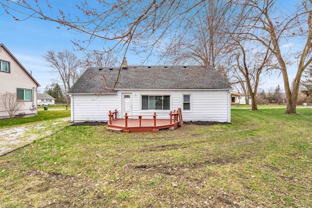 back of property featuring a yard and a wooden deck