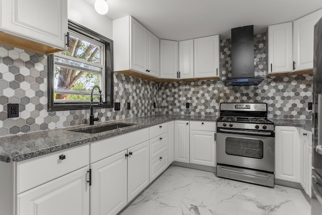 kitchen featuring white cabinets, wall chimney range hood, sink, and stainless steel gas range