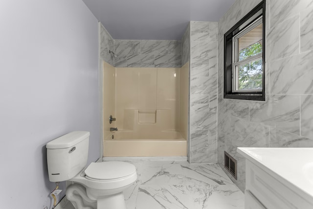 full bathroom featuring tiled shower / bath combo, toilet, and vanity