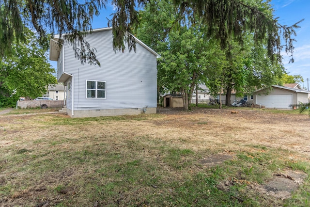 view of property exterior with a lawn and a storage shed