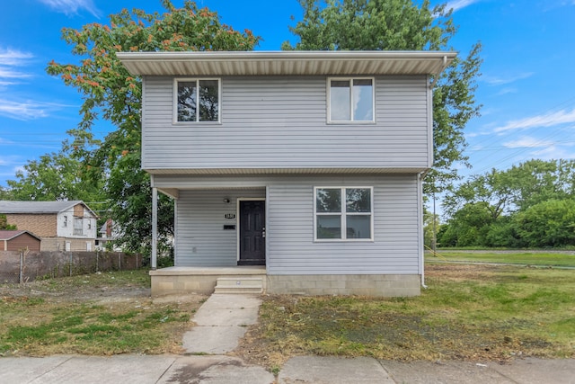 view of front of home with covered porch and a front yard