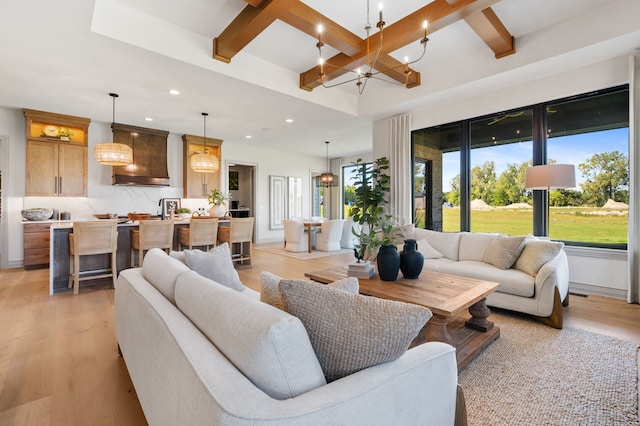 living room featuring coffered ceiling, beam ceiling, and light hardwood / wood-style flooring