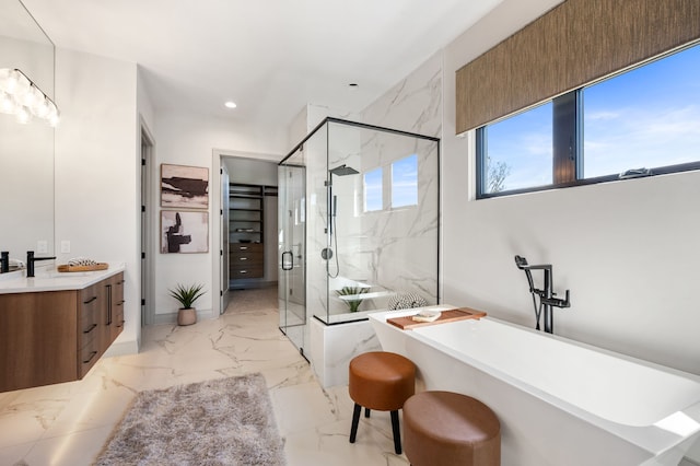 bathroom featuring shower with separate bathtub and vanity